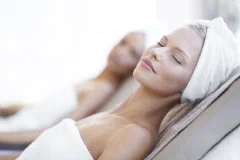 Client relaxing during a facial treatment